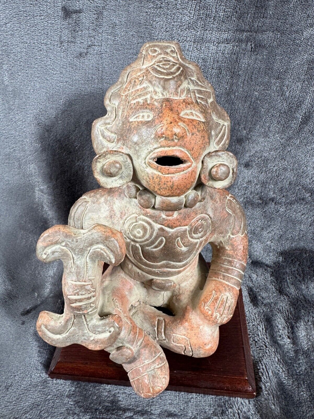 Ancient Clay Warrior Sculpture With Intricate Details On Wooden Base