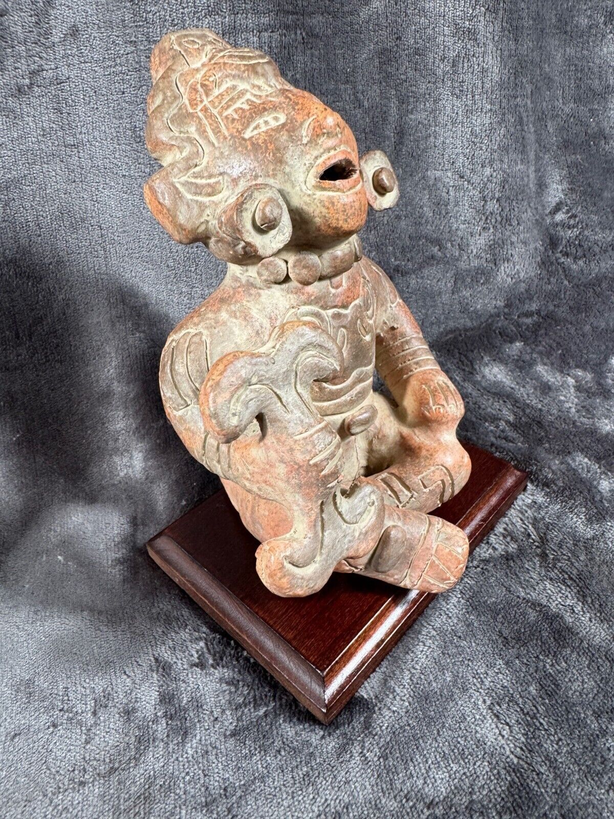 Ancient Clay Warrior Sculpture With Intricate Details On Wooden Base