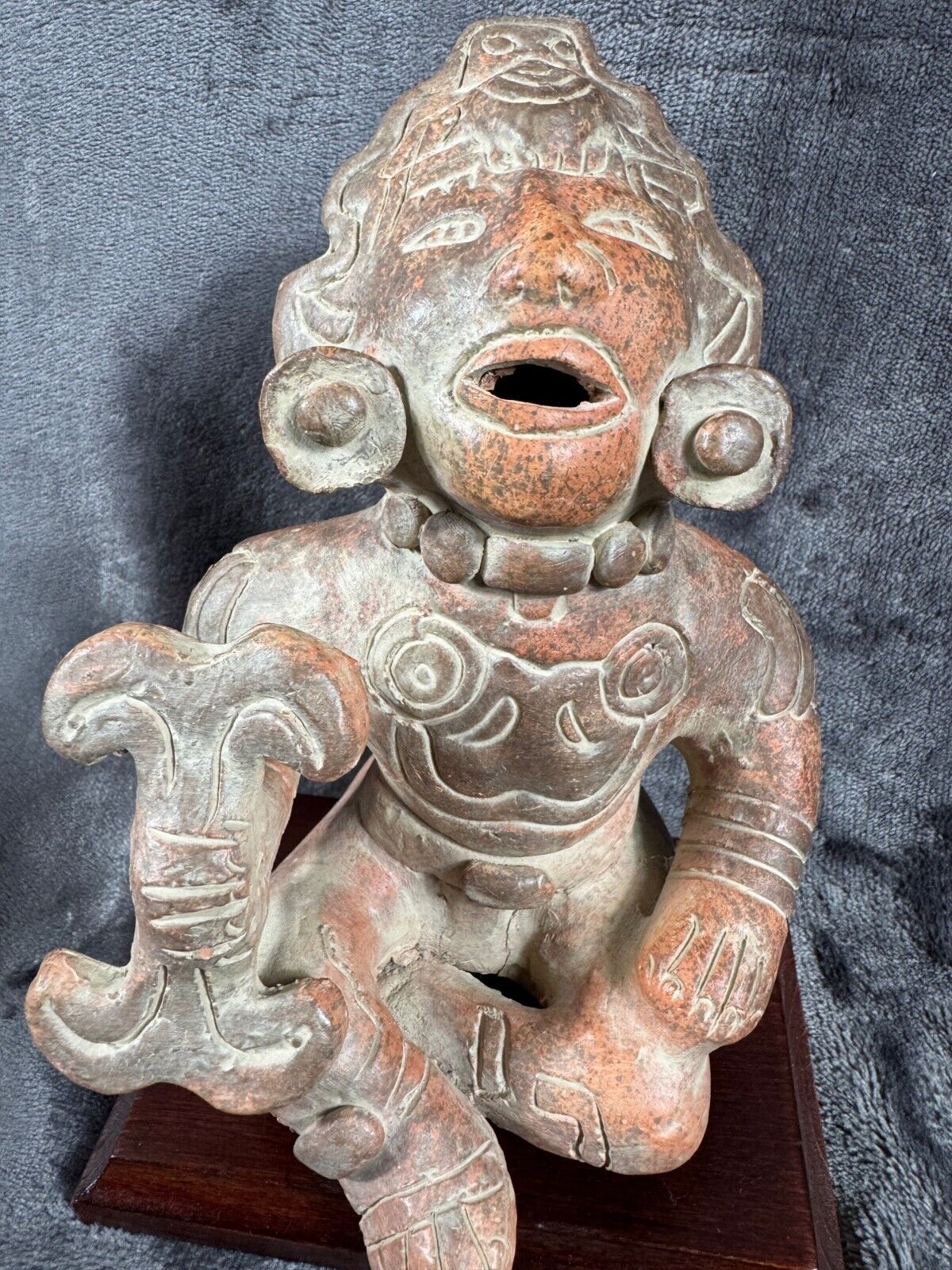 Ancient Clay Warrior Sculpture With Intricate Details On Wooden Base