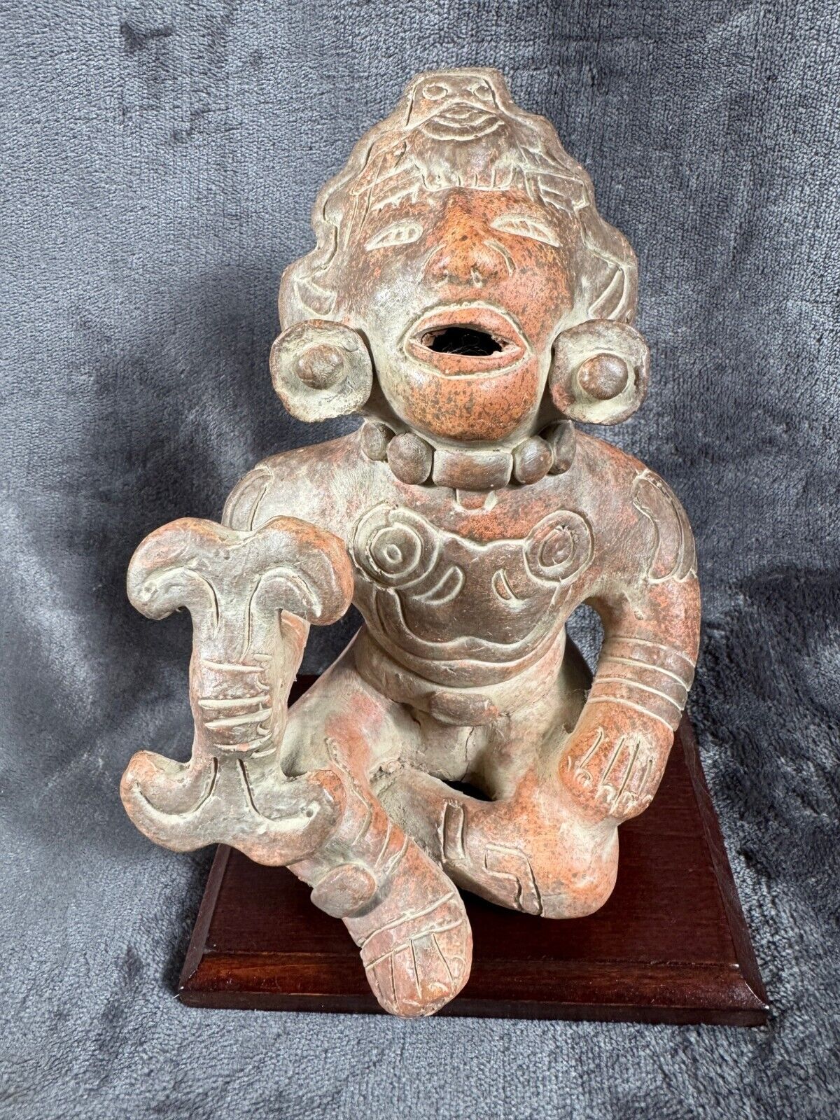 Ancient Clay Warrior Sculpture With Intricate Details On Wooden Base