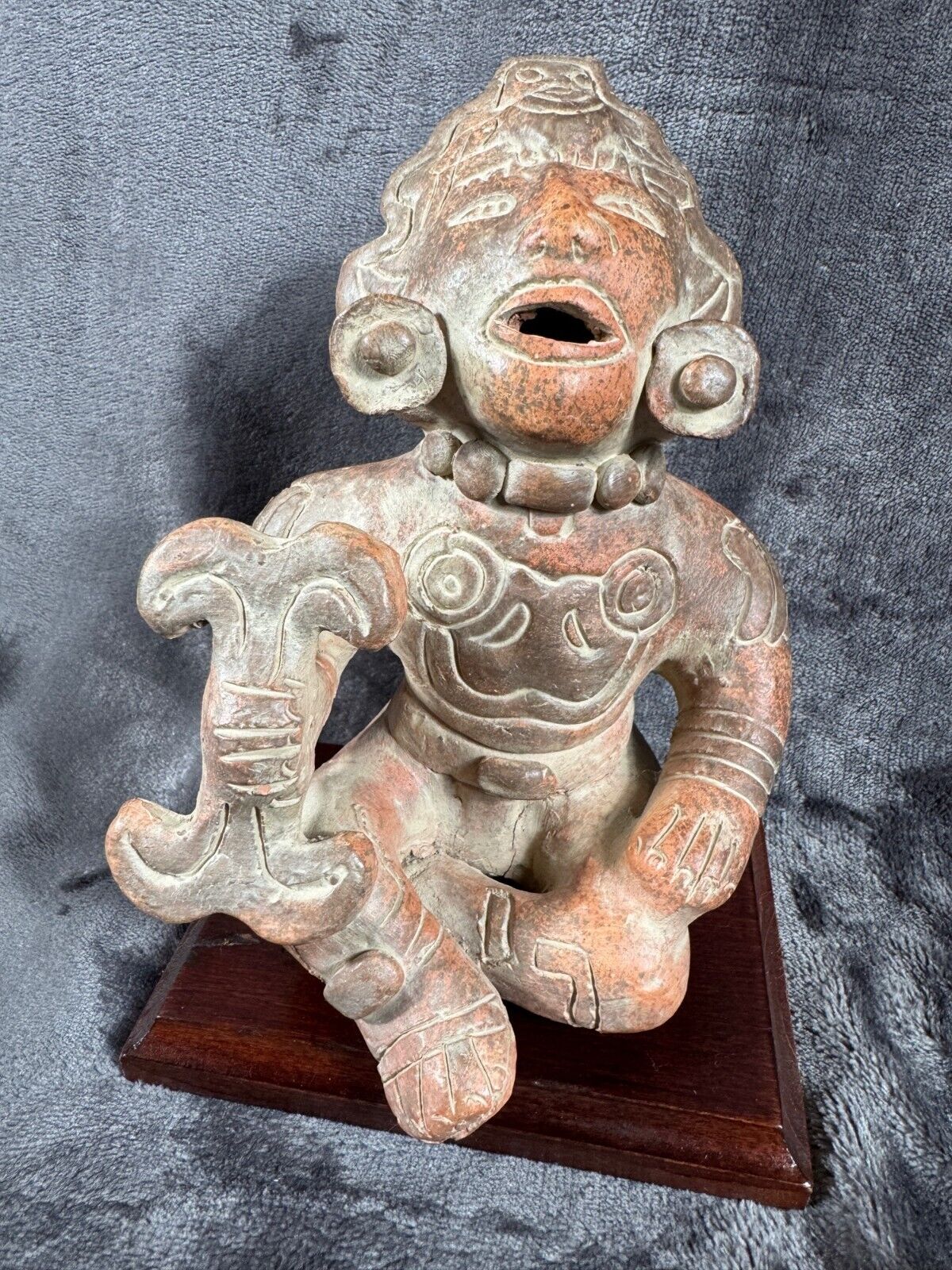 Ancient Clay Warrior Sculpture With Intricate Details On Wooden Base